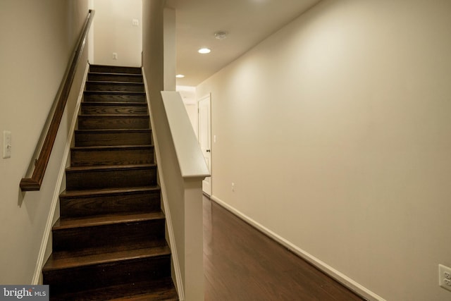 staircase with hardwood / wood-style floors