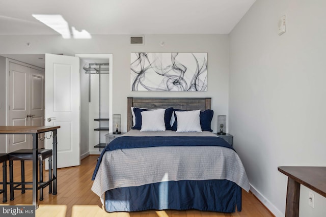 bedroom featuring hardwood / wood-style flooring and a closet