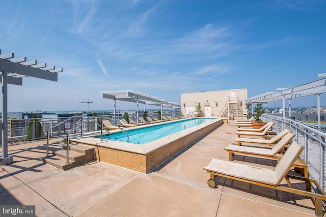 view of swimming pool featuring a patio area and a pergola