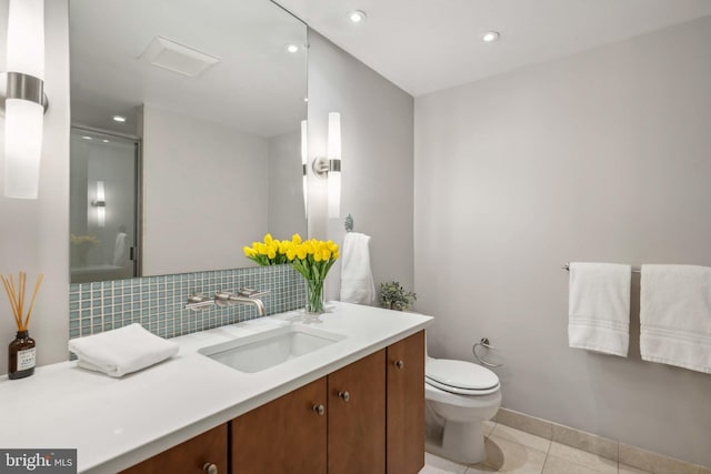 bathroom with backsplash, tile patterned floors, an enclosed shower, toilet, and vanity