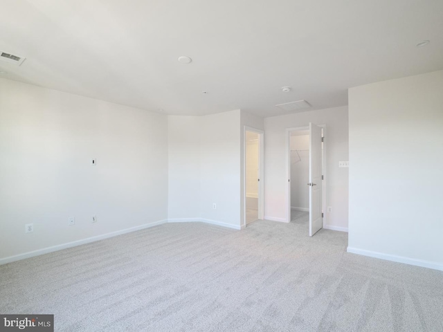 unfurnished room with light colored carpet