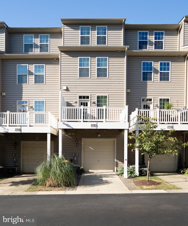 view of front facade featuring a wooden deck and a garage