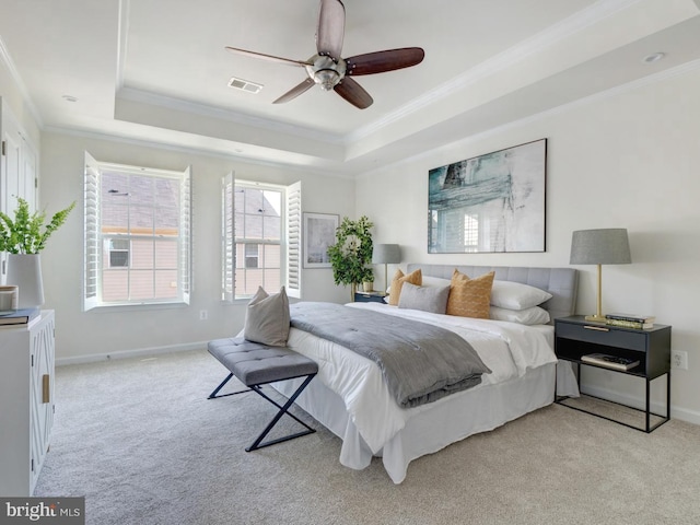 carpeted bedroom with crown molding, a raised ceiling, and ceiling fan