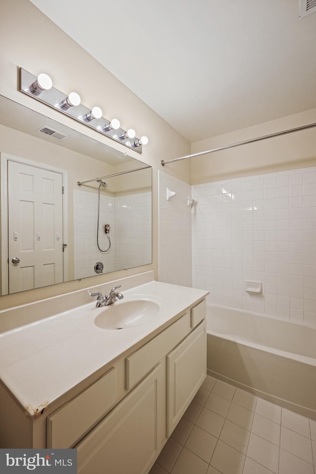 bathroom with vanity, tiled shower / bath combo, and tile patterned floors