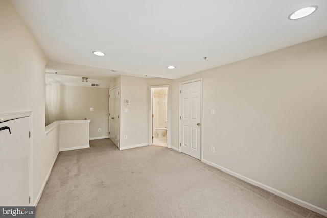 unfurnished room featuring light colored carpet