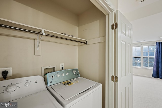 clothes washing area with independent washer and dryer and carpet floors