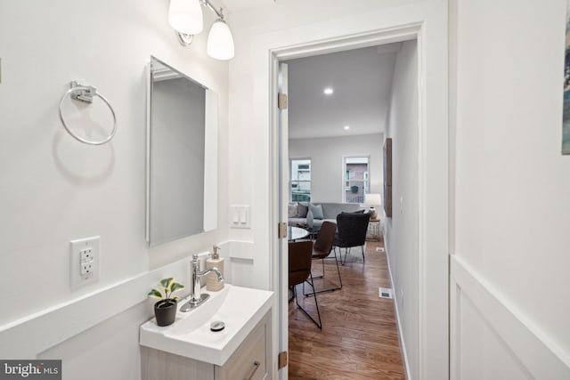 bathroom with vanity and hardwood / wood-style flooring