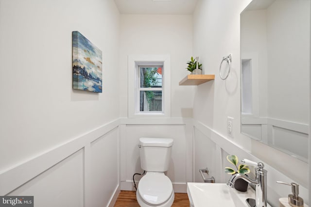 bathroom featuring sink, hardwood / wood-style flooring, and toilet