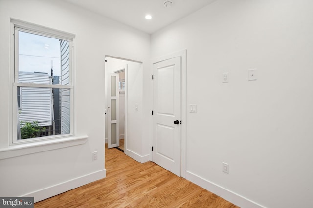 hallway with light hardwood / wood-style flooring