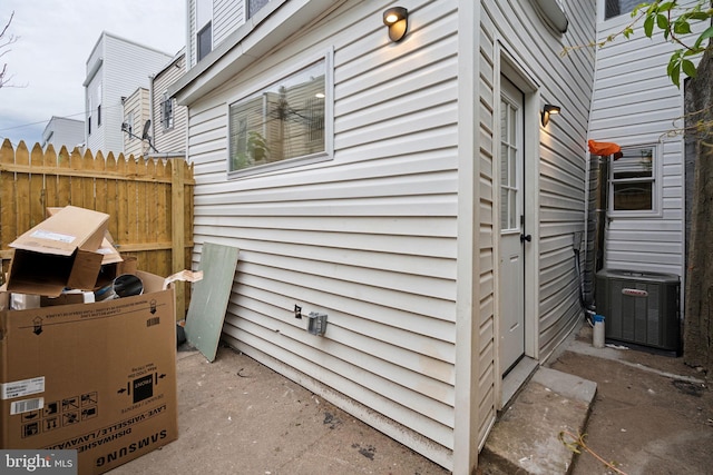 view of side of home with central air condition unit