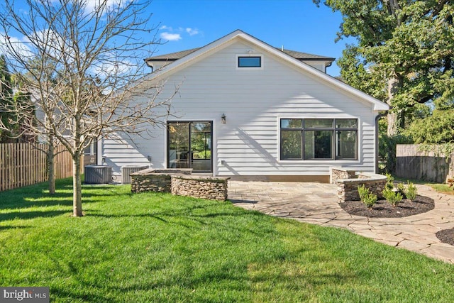 back of property featuring a yard, central air condition unit, and a patio