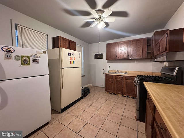 kitchen with gas range, white fridge, sink, and ceiling fan