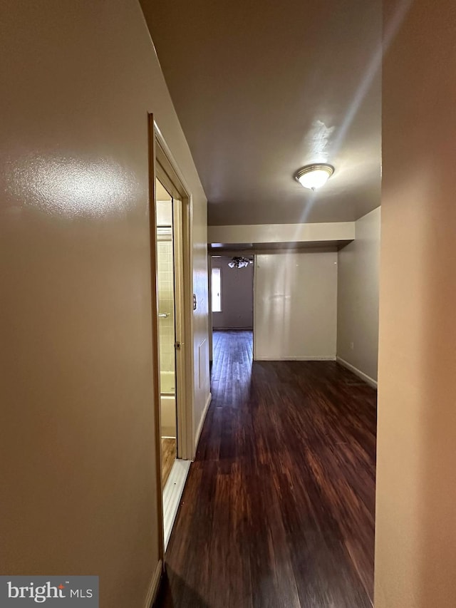 hallway with dark hardwood / wood-style flooring