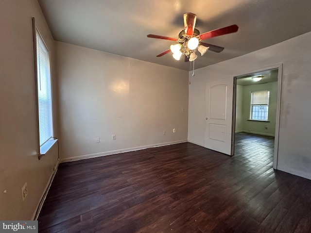 unfurnished room with dark hardwood / wood-style floors and ceiling fan