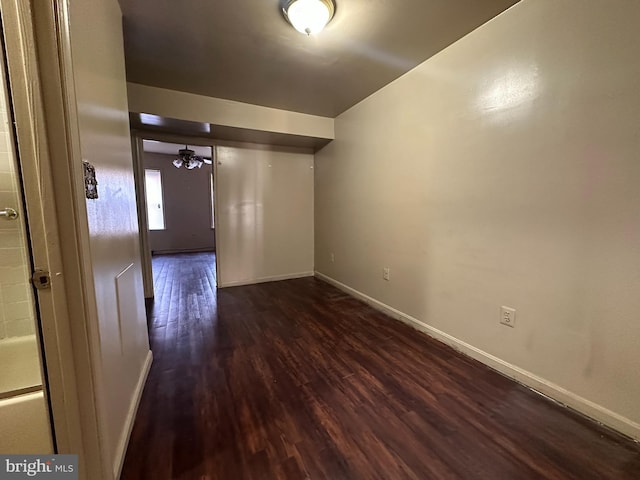 unfurnished room with dark hardwood / wood-style floors and ceiling fan