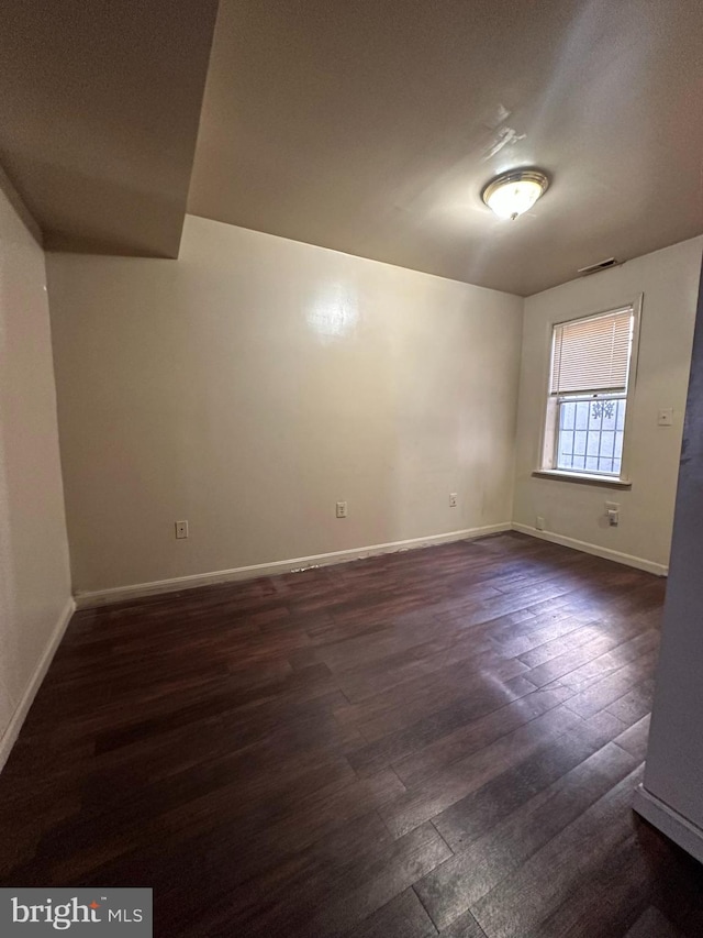 spare room featuring dark hardwood / wood-style flooring