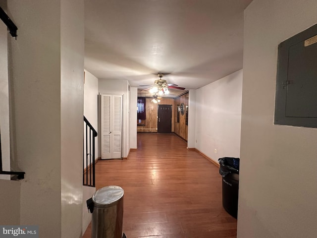 corridor with light hardwood / wood-style floors and electric panel