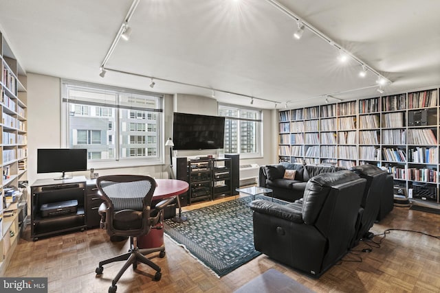 living room with parquet flooring and track lighting