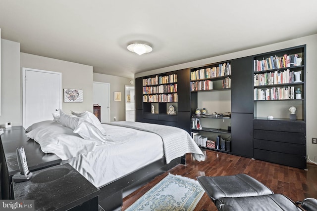 bedroom with dark hardwood / wood-style floors