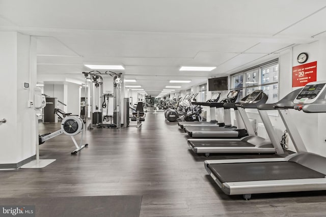 workout area with dark wood-type flooring