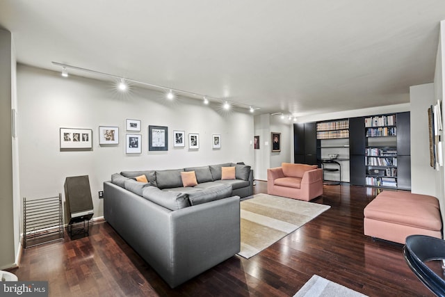 living room featuring track lighting and dark wood-type flooring