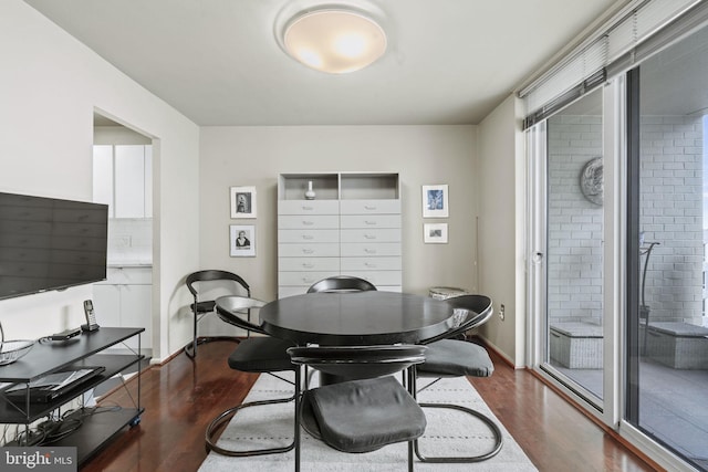 dining space featuring dark wood-type flooring and plenty of natural light