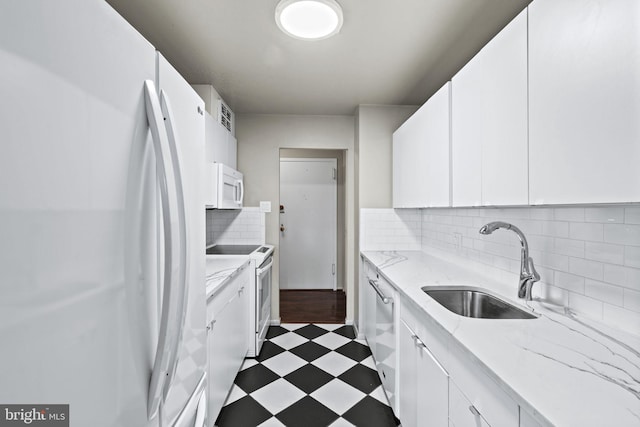 kitchen featuring tasteful backsplash, white appliances, sink, and white cabinets