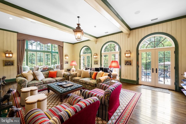 living room featuring french doors, hardwood / wood-style flooring, plenty of natural light, and crown molding