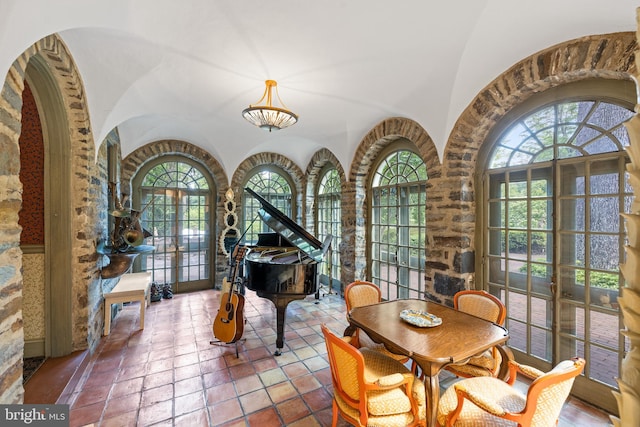 interior space featuring lofted ceiling and tile patterned flooring