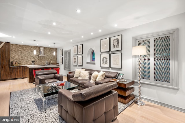 living room featuring indoor wet bar and light wood-type flooring