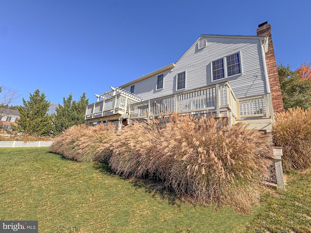 exterior space with a front lawn and a deck