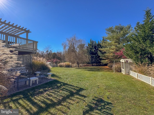 view of yard with a patio area and a wooden deck