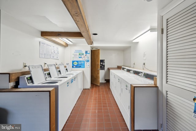 clothes washing area with independent washer and dryer and dark tile patterned floors