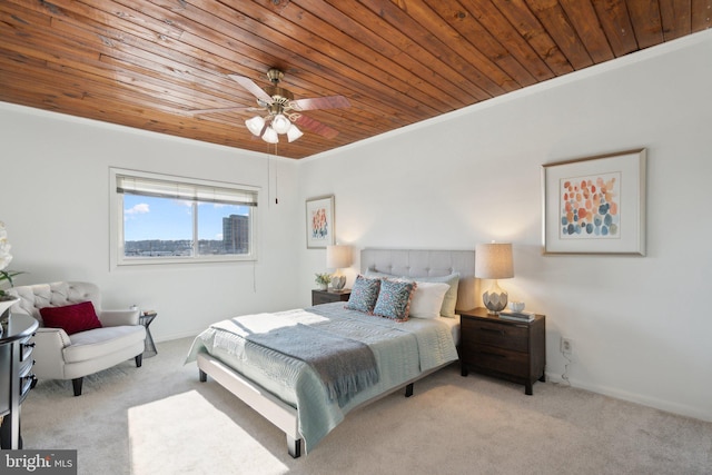 bedroom with wood ceiling, ornamental molding, light colored carpet, and ceiling fan