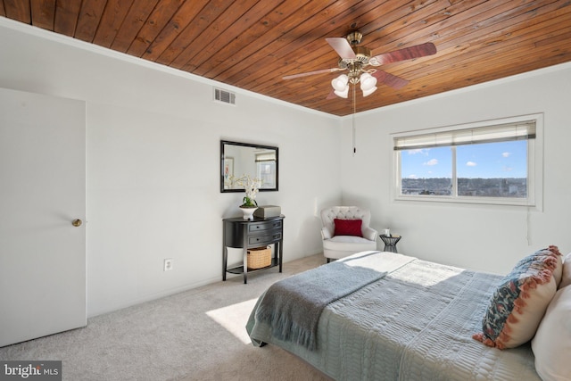 carpeted bedroom with ornamental molding, wooden ceiling, and ceiling fan