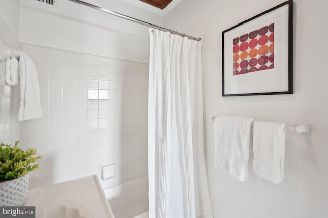 bathroom featuring shower / bath combo with shower curtain