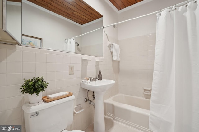 bathroom with tile walls, ornamental molding, toilet, wooden ceiling, and shower / bath combo with shower curtain