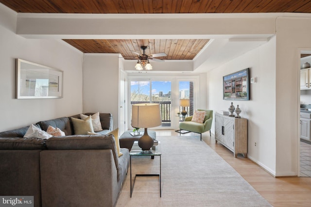 living room with ornamental molding, ceiling fan, wood ceiling, and light hardwood / wood-style flooring