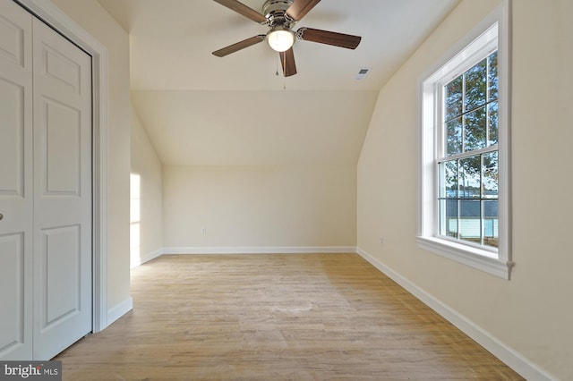 additional living space with ceiling fan, lofted ceiling, light hardwood / wood-style floors, and plenty of natural light