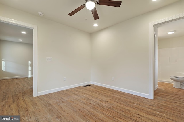 unfurnished room with light wood-type flooring and ceiling fan