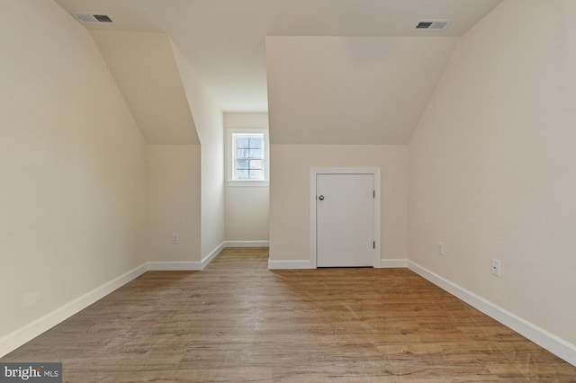 bonus room featuring light hardwood / wood-style flooring and vaulted ceiling