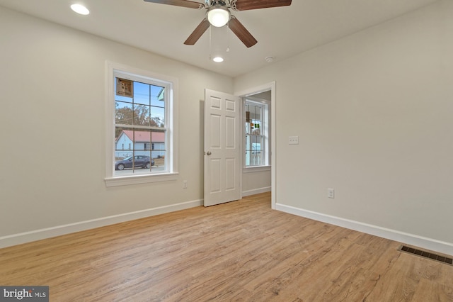 unfurnished room with ceiling fan and light hardwood / wood-style flooring