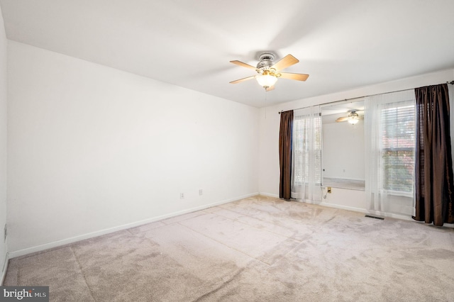 unfurnished room featuring ceiling fan and light colored carpet