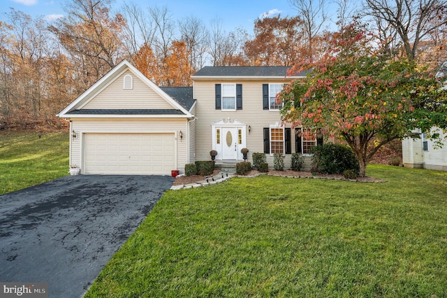 view of front of property with a garage and a front lawn