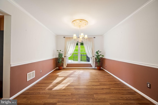 unfurnished dining area with wood-type flooring, an inviting chandelier, and crown molding