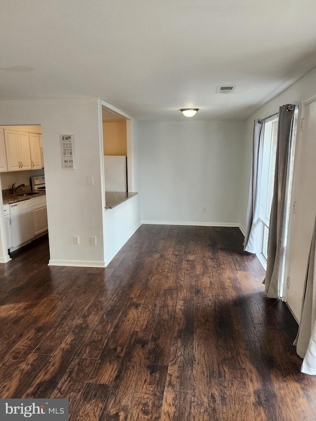 unfurnished room featuring dark hardwood / wood-style floors