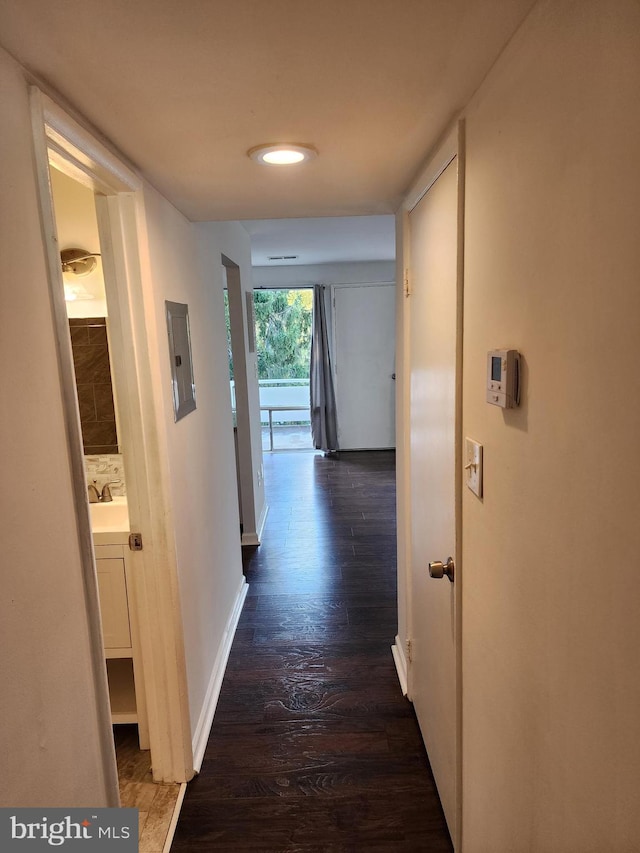 hallway with sink and dark hardwood / wood-style flooring