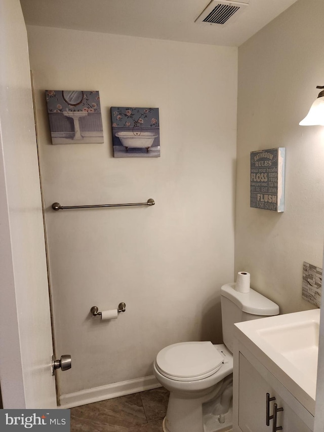 bathroom with vanity, toilet, and tile patterned flooring