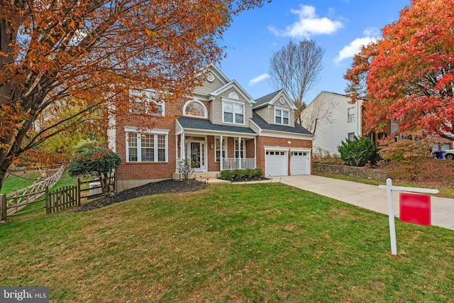 view of front facade featuring a front yard, a porch, and a garage