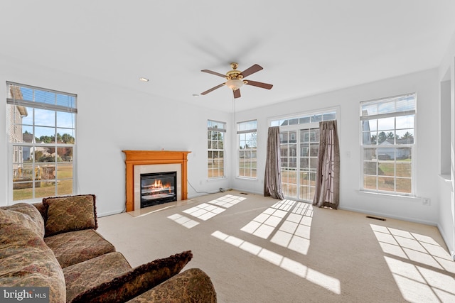 carpeted living room featuring ceiling fan and plenty of natural light